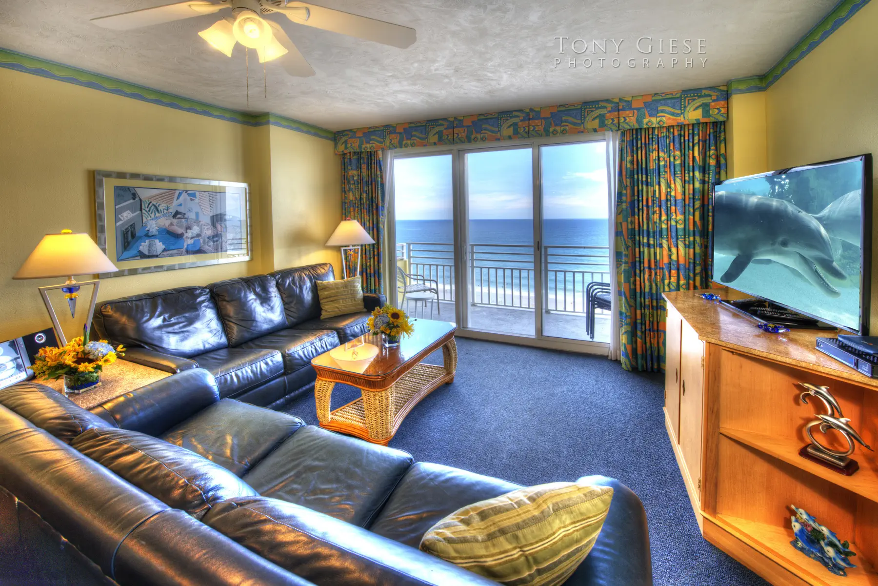 Condo living room view faces the ocean – 51 in flat screen HD TV, with premium cable and WiF on Daytona Beach, Florida. Photography by Tony Giese. Wyndham Ocean Walk Resort.
